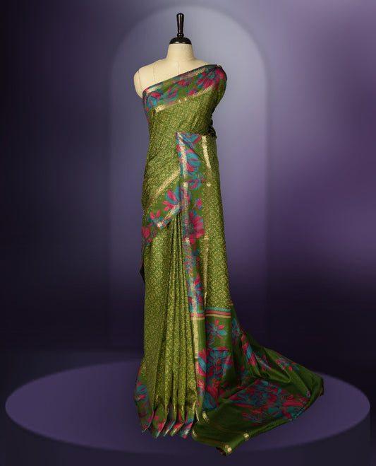 Green colour saree enhanced with a vibrant golden border and floral print pallu, adorned with intricate teal and pink floral prints on the body & comes with a matching blouse.