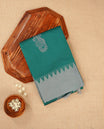 Dark teal colour silk cotton saree featuring ash teal colour thread motifs on body thread detiled contrast borders & pallu,comes with matching blouse piece