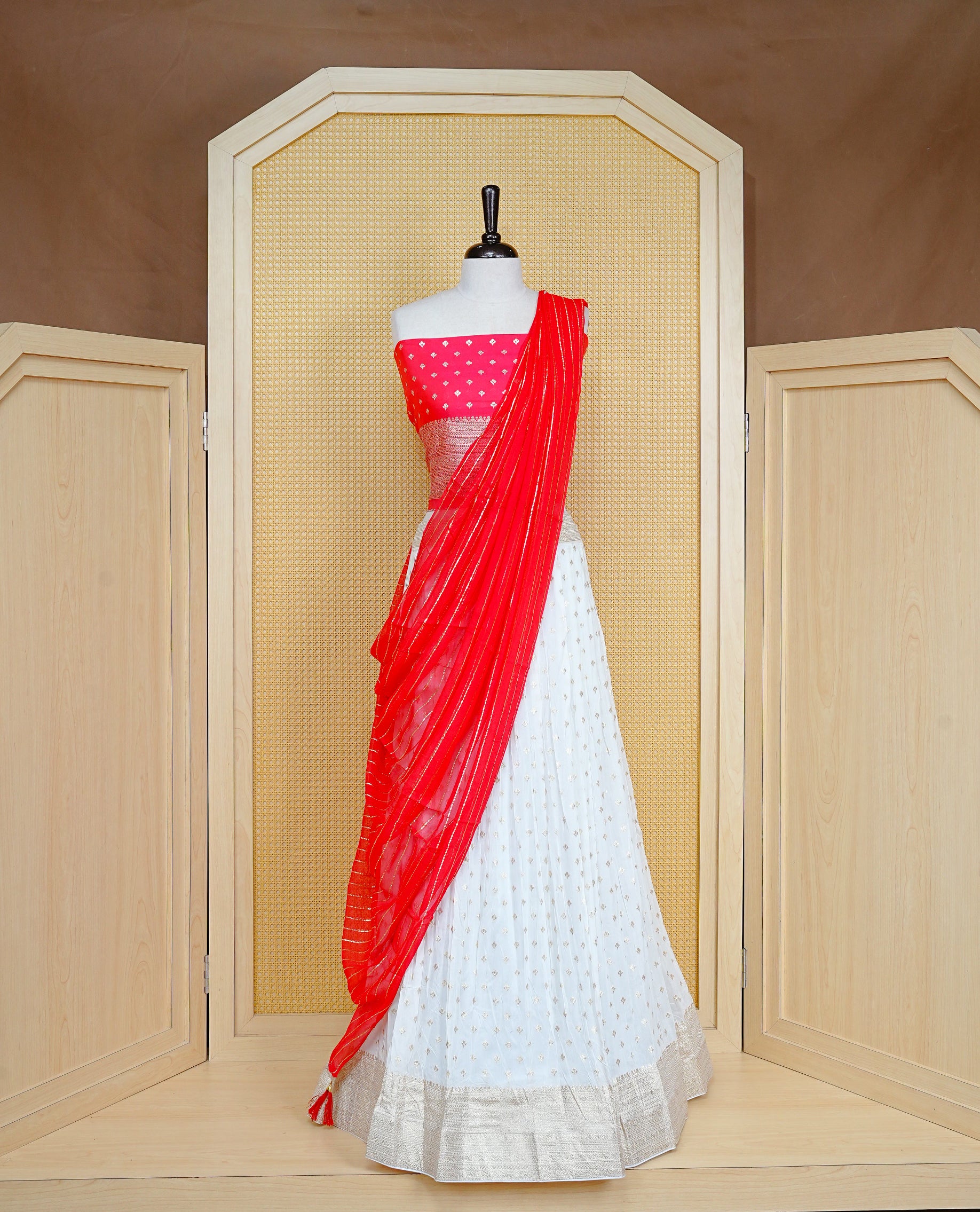 Cream colour Semi Stitched Dhavani Set Cream colour Skirt With Floral Motifs on Border, Paired with Contrast Red colour With Gold zari motifs on Unstitched Blouse, Elegant Dupatta For Prefect look.