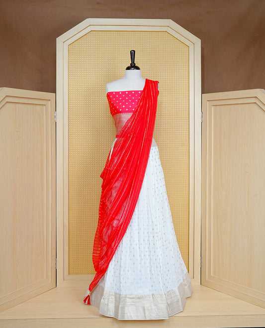 Cream colour Semi Stitched Dhavani Set Cream colour Skirt With Floral Motifs on Border, Paired with Contrast Red colour With Gold zari motifs on Unstitched Blouse, Elegant Dupatta For Prefect look.
