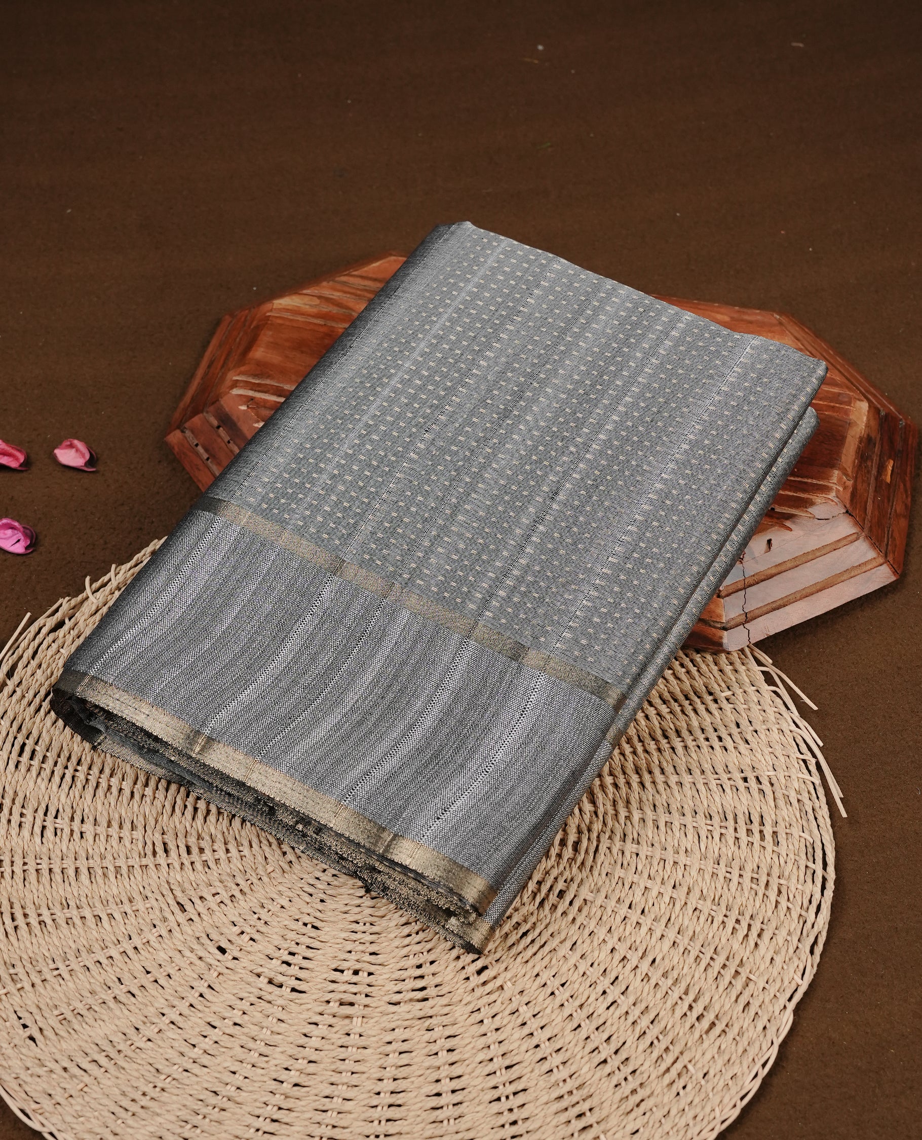Grey colour semi tussar silk saree featuring elegant gold zari dotted stripes across the body, enhanced with a rich zari woven border. Comes with a matching blouse piece.
