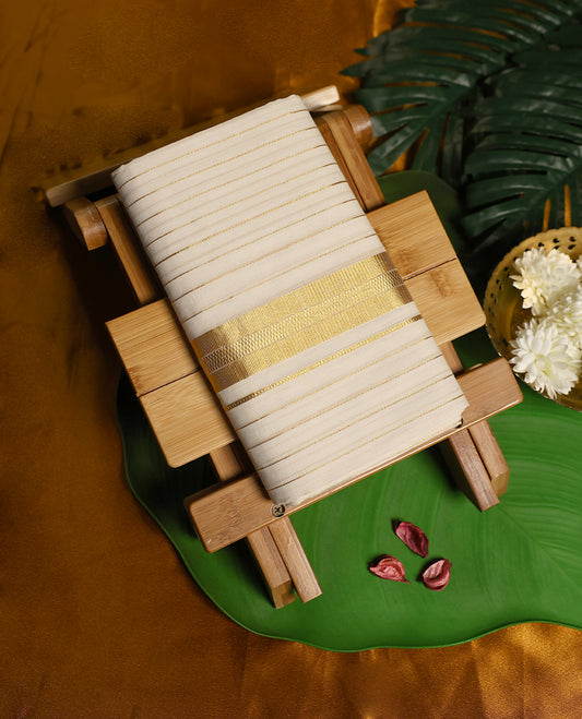 Ivory pure handloom soft cotton double dhoti accentuated with fine golden zari stripes and a broad zari border, blending comfort with traditional elegance, ideal for weddings, rituals, and festive occasions.