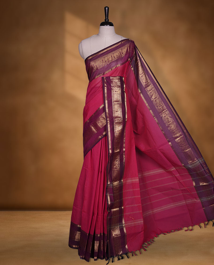 Rani pink colour chettinad cotton saree featuring plain body, contrast burgundy colour with traditional gold zari border paired with matching blouse.