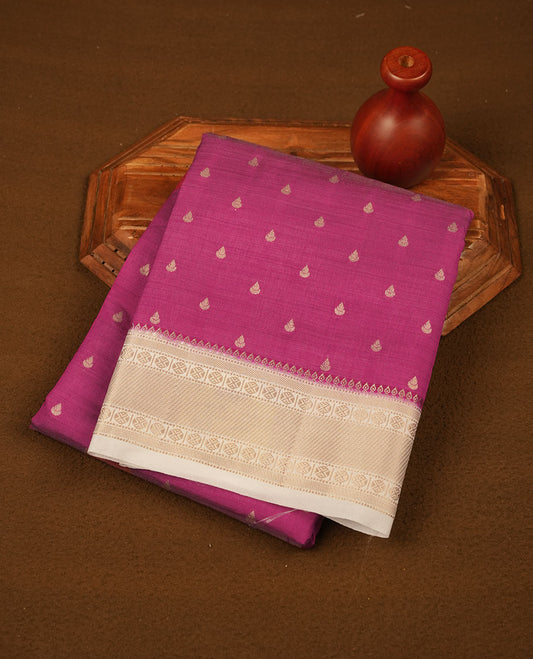 Dark Pink colour tussar saree featuring litte gold zari motifs on body, contrast cream colour border and pallu with zari woven design, comes with matching blouse piece.