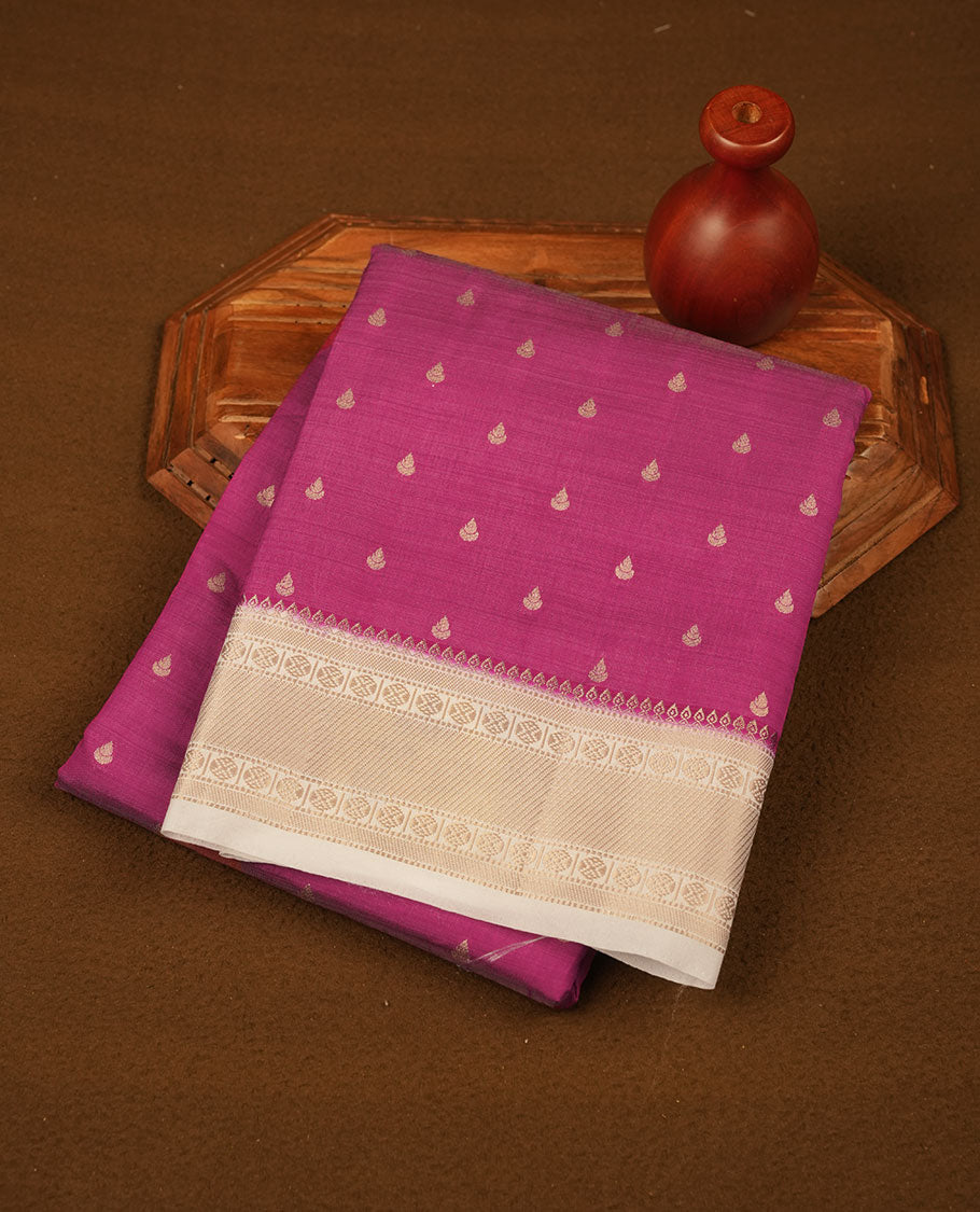 Dark Pink colour tussar saree featuring litte gold zari motifs on body, contrast cream colour border and pallu with zari woven design, comes with matching blouse piece.