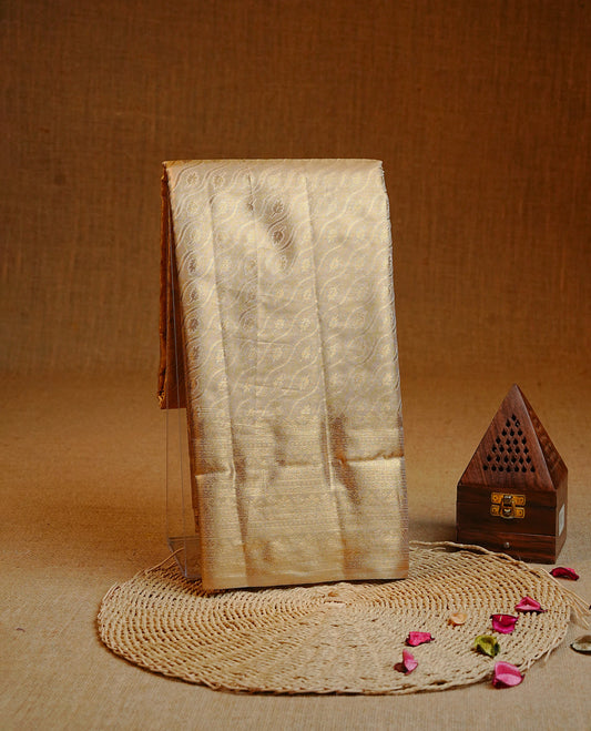 Gold colour Double shade Semi tissue silk saree featuring Light gold zari Wavy & leaf pattern on body, self colour with traditional border, paired with matching.