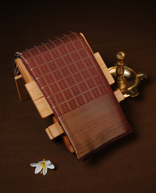 Chocolate brown colour Semi Wedding silk saree featuring Gold zari Check pattern across body, enhanced with self colour with traditional border, paired with matching blouse piece.