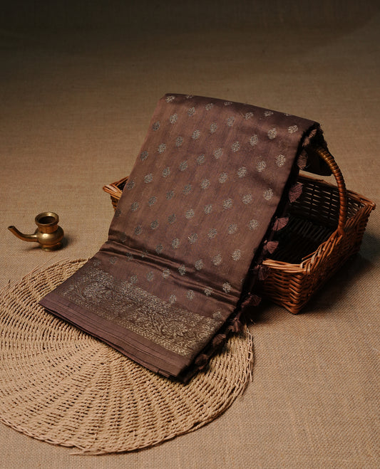 Copper brown colour semi tussar silk saree featuring elegant Antique zari motifs across the body, designed with a subtle borderless zari finish for a sophisticated traditional look. Paired with a matching blouse piece.