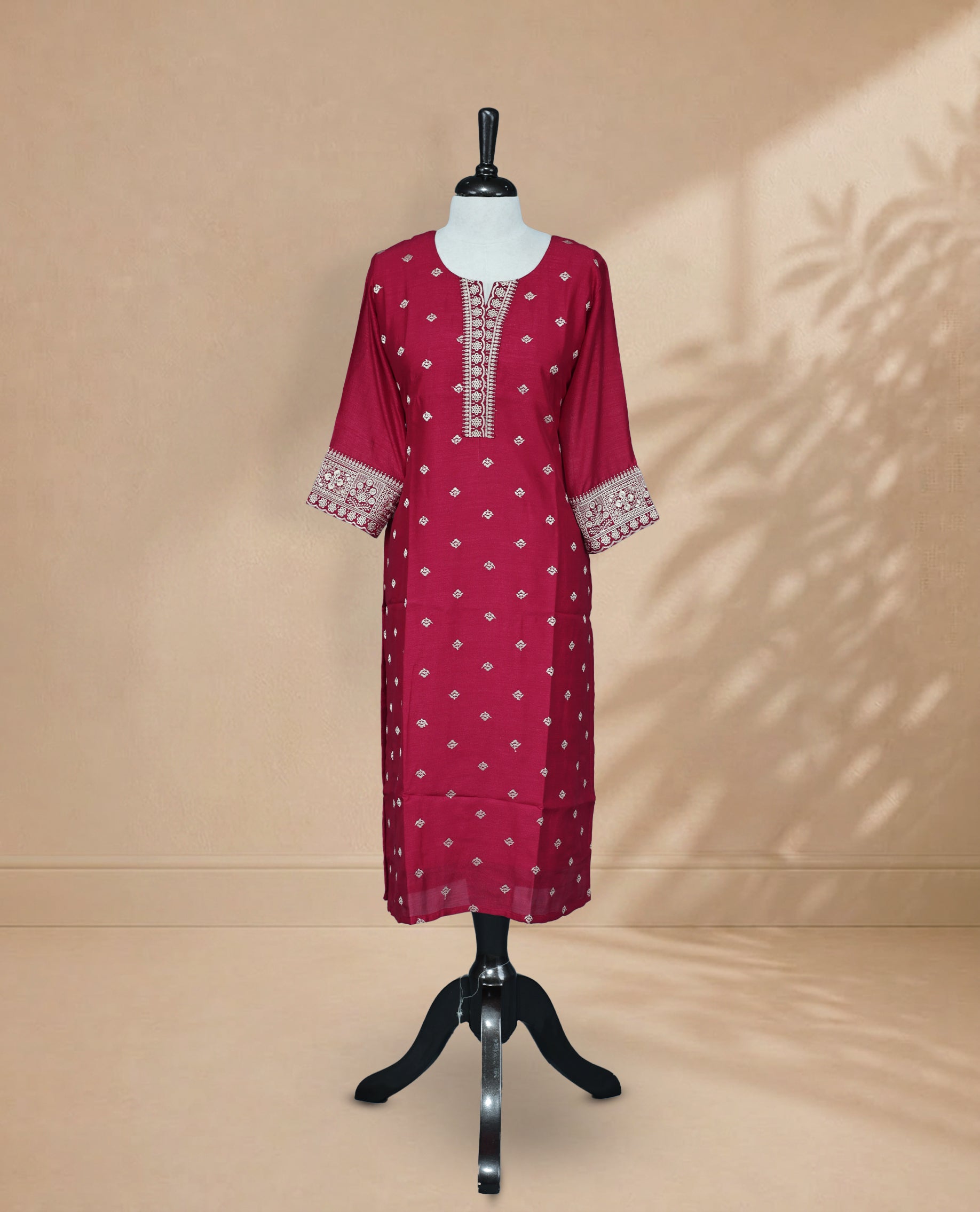 Red Kurti featuring threadwork across the body, a U-shaped neckline adorned with threadwork, and 3/4 sleeves with matching threadwork.