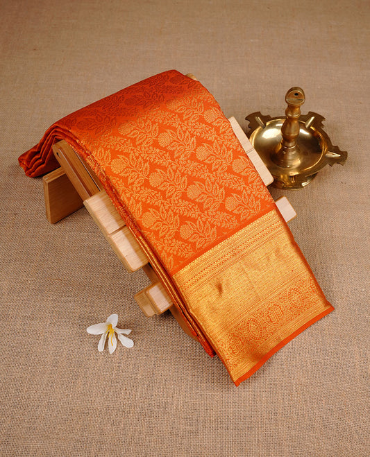 Orange colour kancheepuram silk saree featuring gold zari pattern across body, complemented by selfcolour border traditional zari border, paired with matching blouse piece.