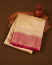 Cream colour tussar silk saree featuring elegant plain body, contrast meganta colour border with gold zari, comes with matching blouse piece.