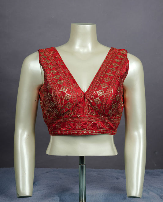 Red colour embroidered sleeveless blouse with intricate geometric motifs, deep V neckline, and tie-up back detailing for a chic finish.