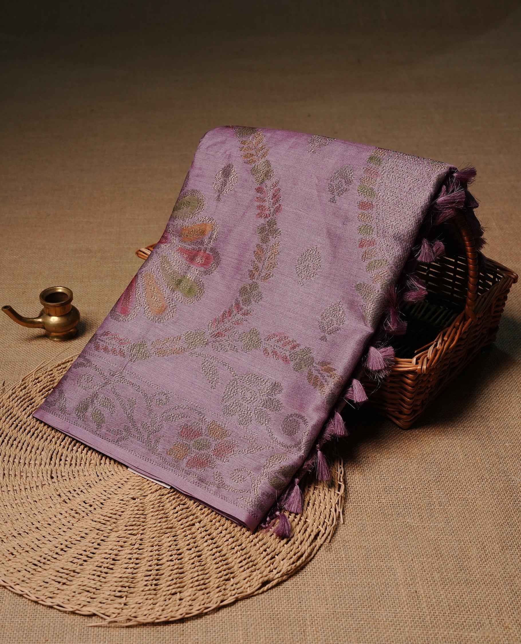 Pastel purple colour pure tussar silk saree featuring elegant antique zari kodi patterns across the body, designed with a graceful borderless finish for a refined look. Paired with a matching blouse piece.