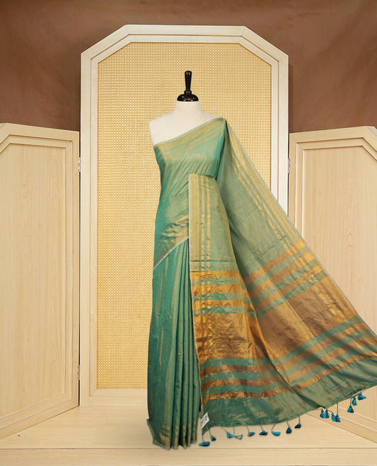 Aqua colour Semi Tissue Silk saree featuring Elegant plain body, Enhanced with Gold tissue Border & Striped Pallu & beautiful Tassels for Elegant Prefect Look.