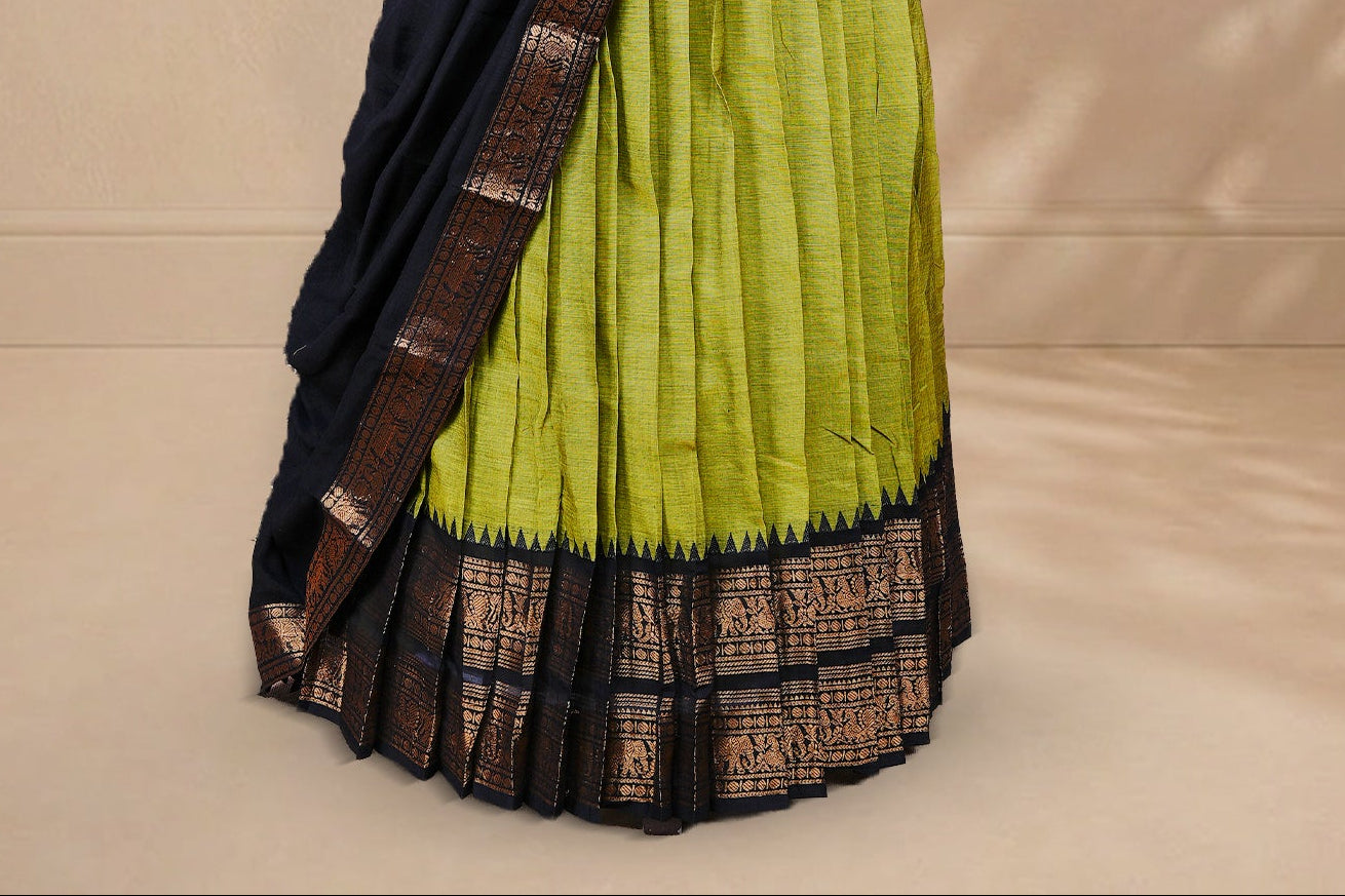 Olive green colour Half saree featuring Plain skirt with Zari border on contrast black colour border, Unstitched Blouse and matching dupatta.