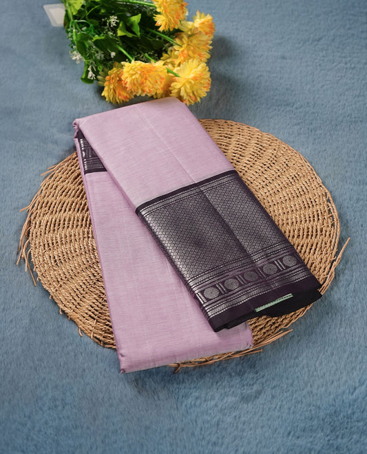 Lavender colour Narayanapattu cotton saree featuring a self coloured body, contrast deep Purple colour with silver zari border and pallu, pairing a matching blouse piece.