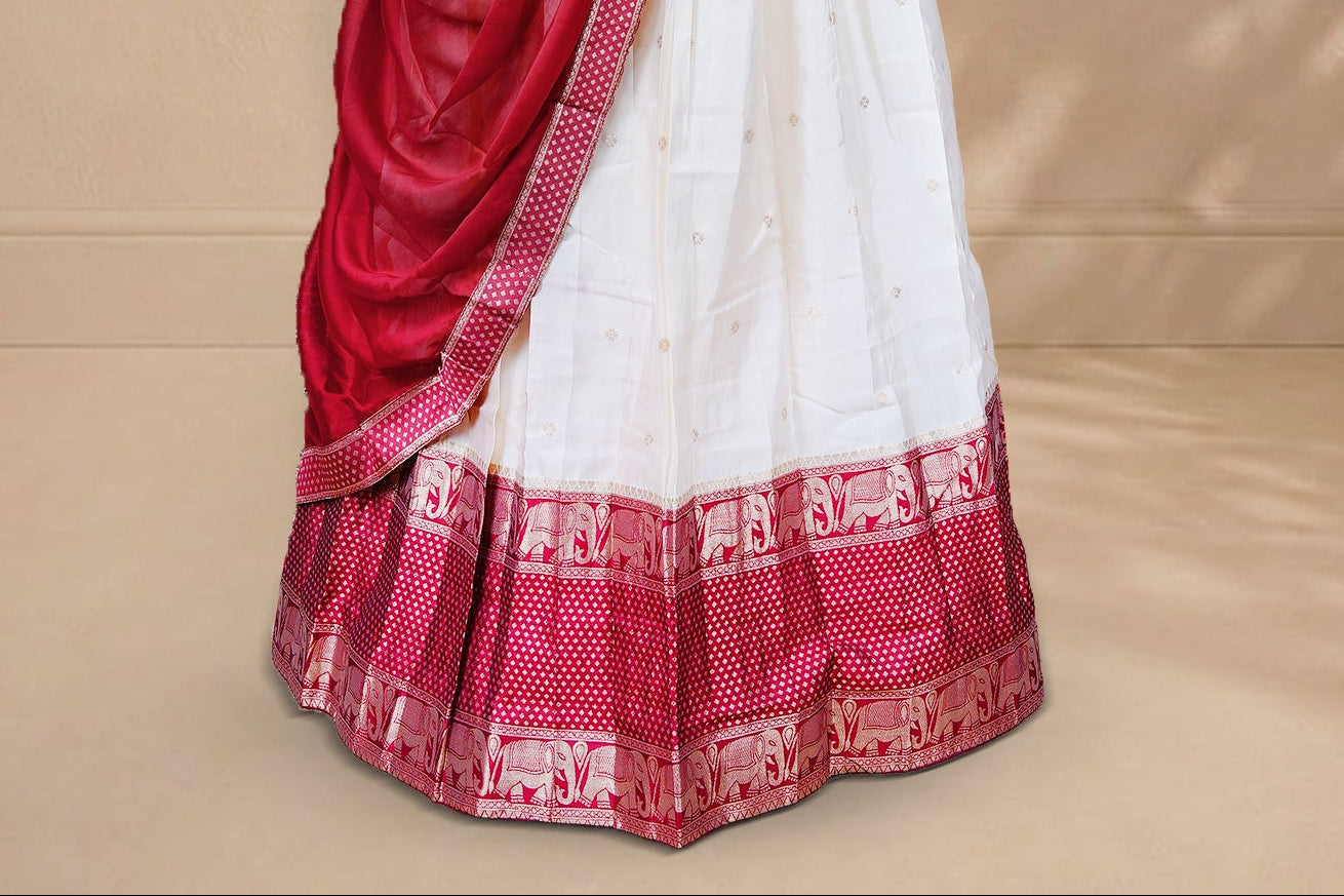 Cream colour Half saree featuring Gold zari buttas on skirt with Zari border on contrast Red colour border, Unstitched Blouse and matching dupatta.