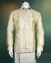 Elegant cream silk shirt featuring intricate golden thread embroidery on the yoke, styled with a classic collar, full sleeves, and buttoned front, ideal for weddings, festive, and traditional occasions.