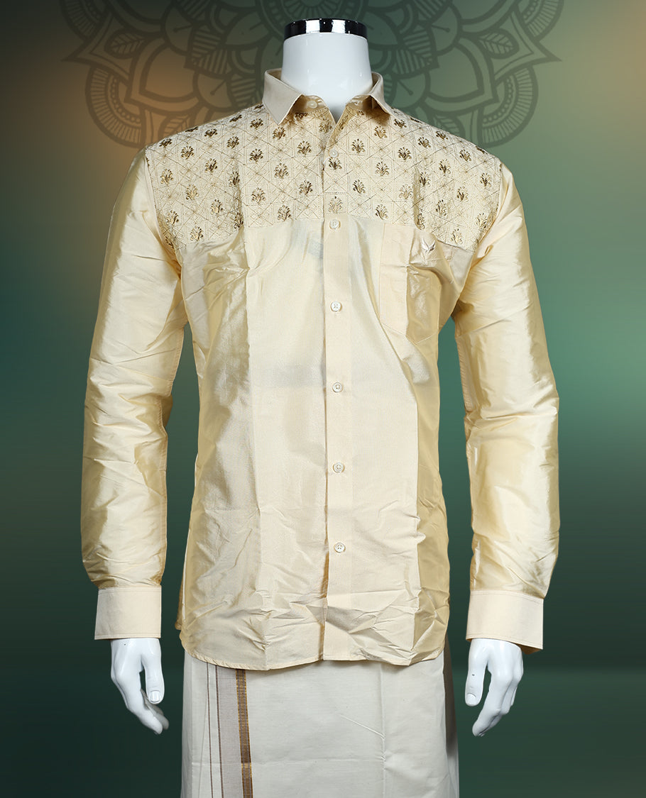 Elegant cream silk shirt featuring intricate golden thread embroidery on the yoke, styled with a classic collar, full sleeves, and buttoned front, ideal for weddings, festive, and traditional occasions.