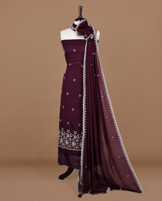 Maroon colour churidhar material featuring gold thread floral pattern on body, paired with matching bottom & dupatta.