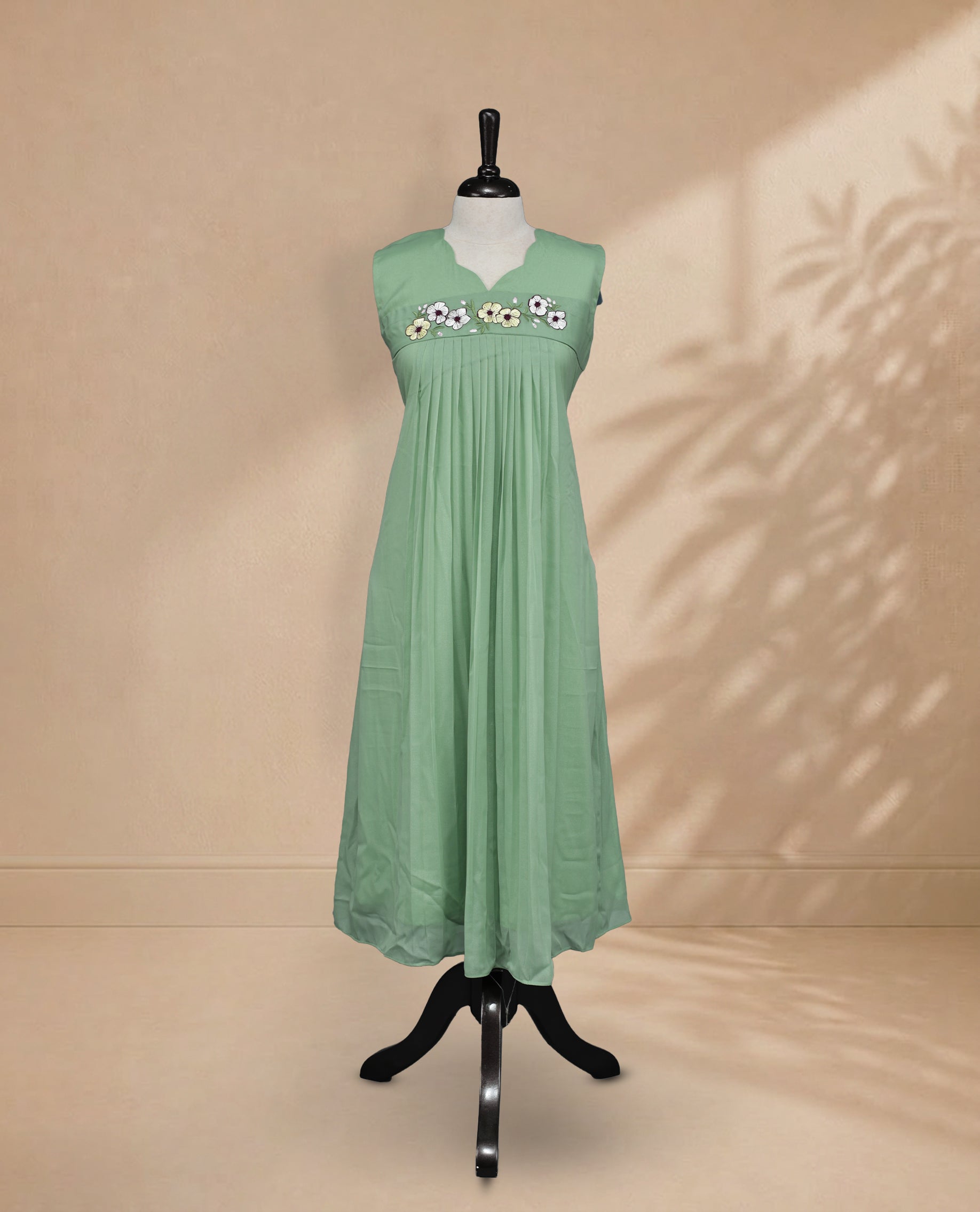 Pista Coloured Sleeveless Kurti Featuring a Designed Neckline, Floral Embroidery on the Body