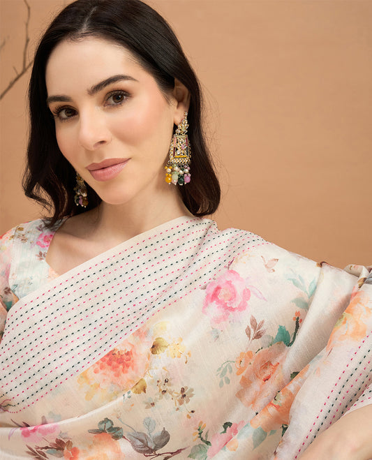 Cream toned semi tussar saree featuring delicate multicolour floral prints on the body, accented with a pastel hued Katha style stitched border and printed pallu Comes with a matching floral printed blouse for a graceful look.