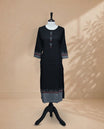 Black Kurti featuring vertical grey stripes on the bottom, a round neckline adorned with red and grey triangular detailing, and 3/4 sleeves with a matching design.