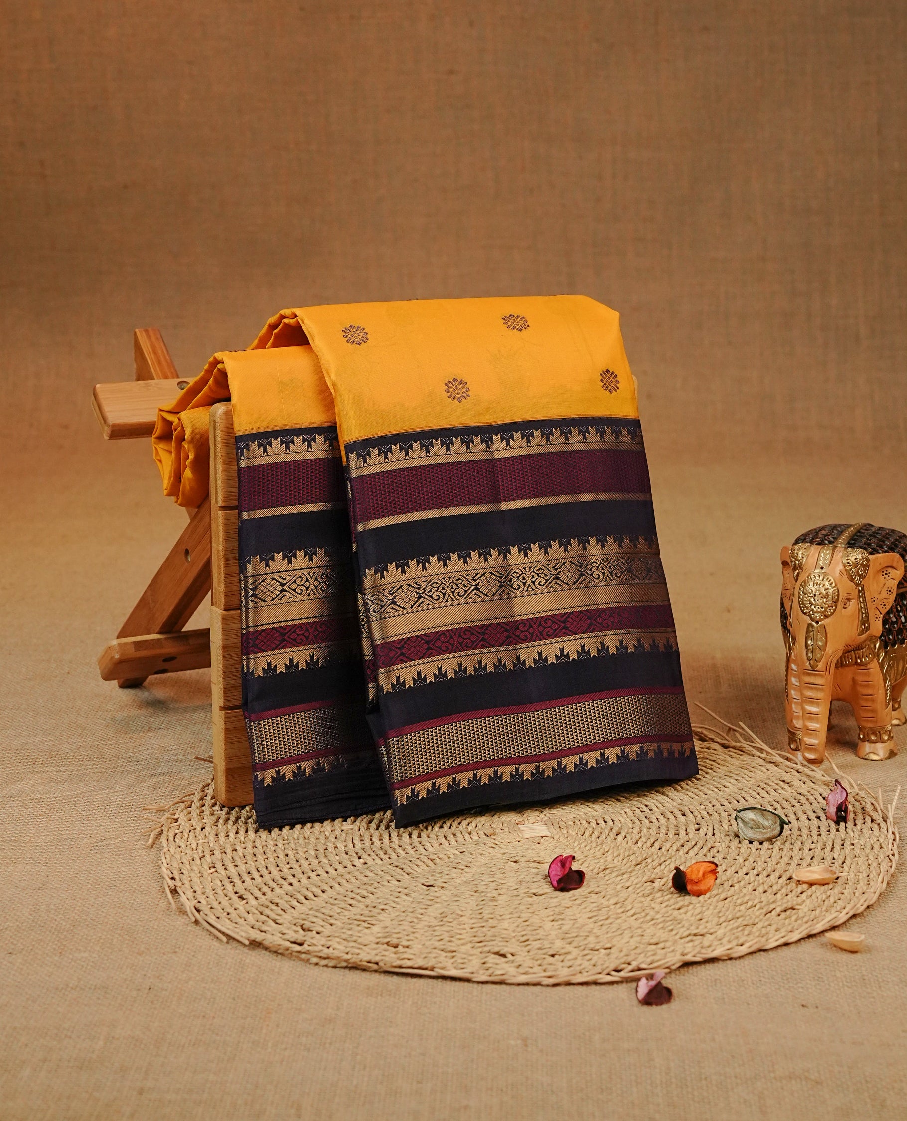 Mustard colour Kancheepuram silk saree featuring Gold zari Motifs on body, complemented by Multicolour with Traditional border, comes with matching blouse piece.