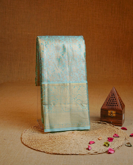 Gold & Ice blue colour Double shade Semi tissue silk saree featuring Gold Floral kodi pattern on body, Contrast Green colour with traditional border, paired with matching.
