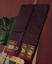 Navy blue Pure Kanchi cotton saree featuring all over checks with floral buttas, accentuated by a striking zari border woven with majestic elephant motifs, blending heritage charm with elegance.