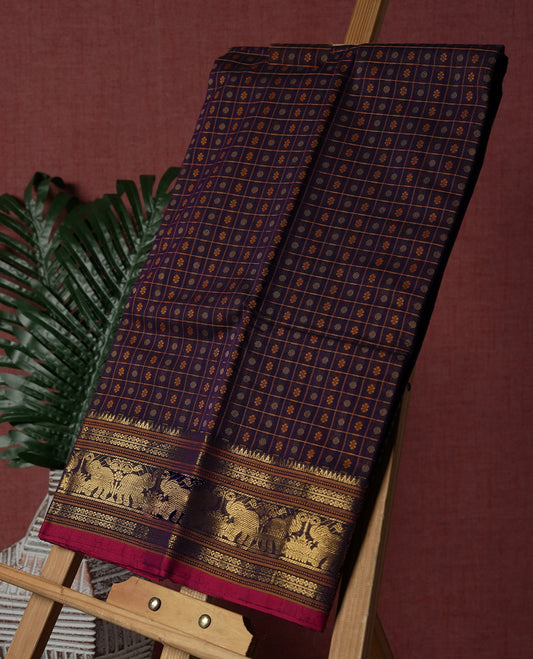 Navy blue Pure Kanchi cotton saree featuring all over checks with floral buttas, accentuated by a striking zari border woven with majestic elephant motifs, blending heritage charm with elegance.