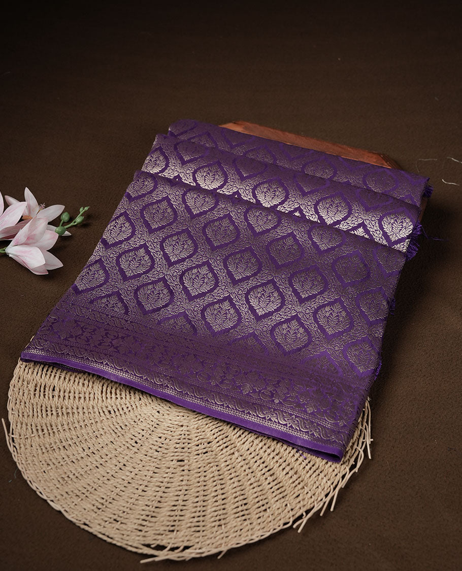 Deep purple colour banaras satin crepe saree featuring gold zari pattern across body, with self colour border with gold zari pattern and paired with matching blouse.