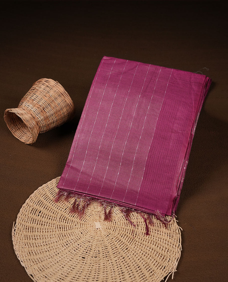 Burgundy colour semi jute saree highlighting gold zari striped body, without border and paired with matching blouse.