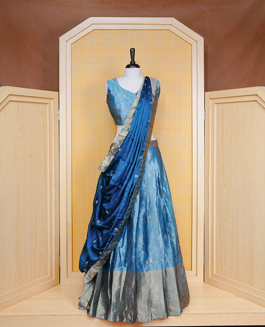 Greyish Blue colour Dhavani set featuring a Greyish blue colour skirt with Self colour border with rich gold zari pattern, paired with a Matching dupatta detailed with Gold motifs