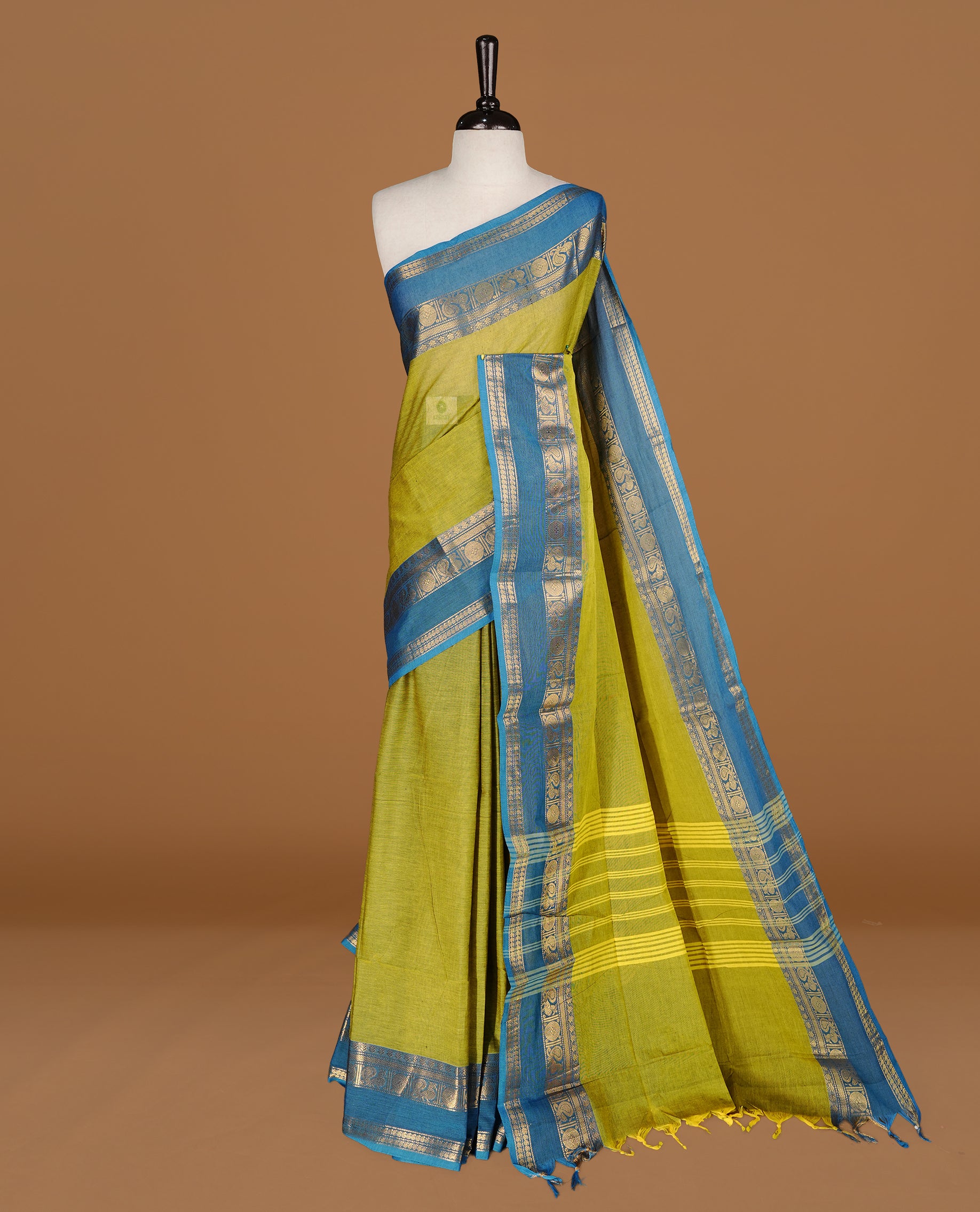 Lemon Green colour Chettinad cotton saree featuring Elegant plain body, complemented by contrast Blue colour with gold zari border, paired with matching blouse piece.