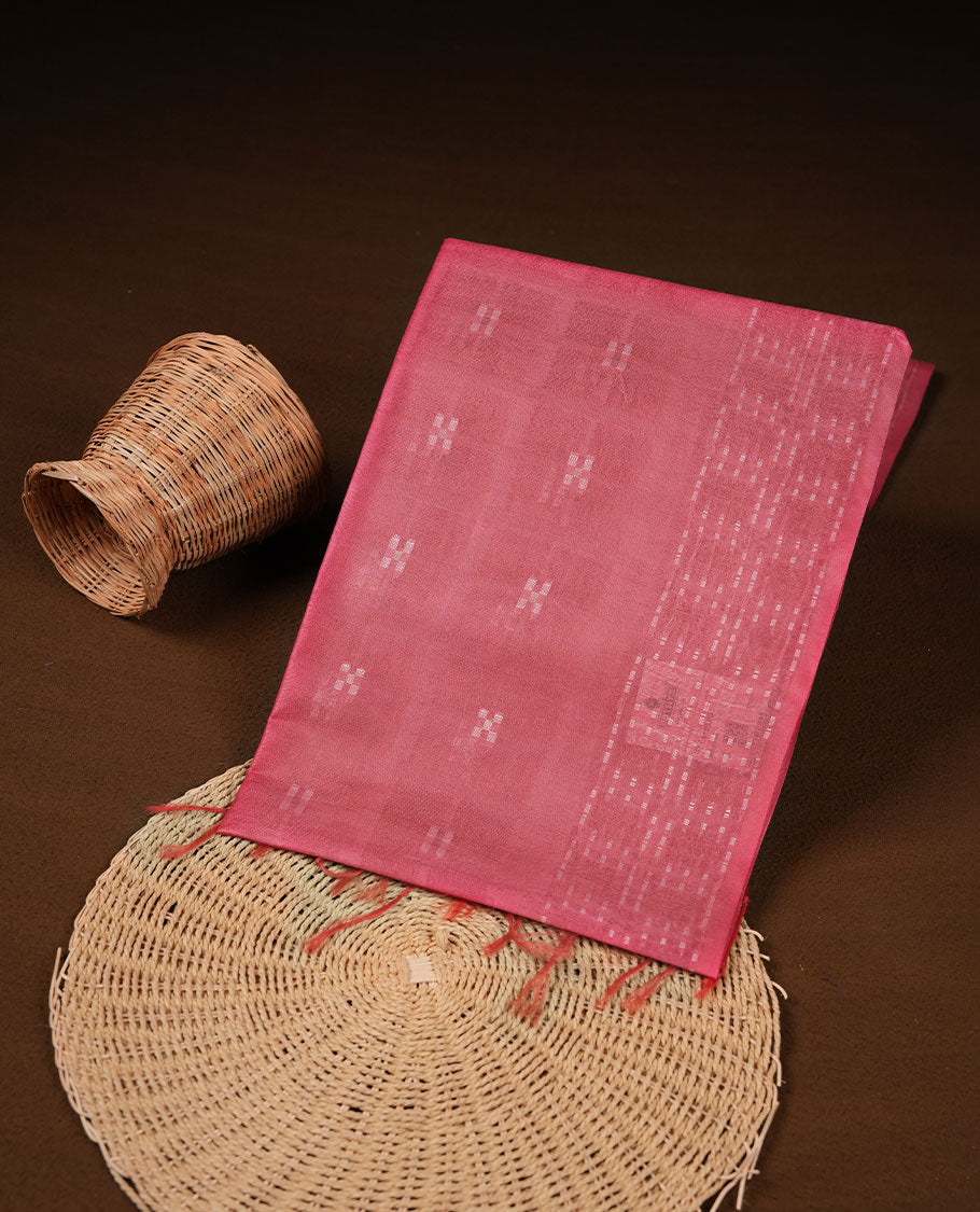 Brick red colour semi jute saree highlighting white thread motifs on body, without border and paired with matching blouse.