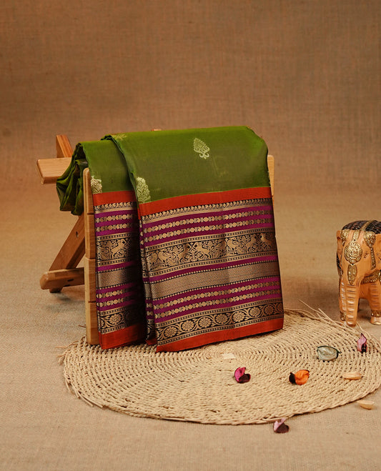 Olive colour Kancheepuram silk saree featuring Gold zari Motifs on body, complemented by Multicolour with Traditional border, comes with matching blouse piece.