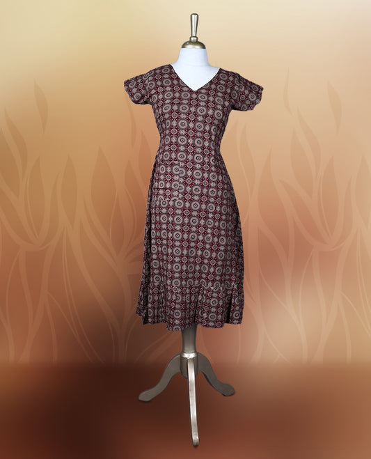 Classy maroon colour nightwear with intricate circular patterns in beige and black, Designed with a V neckline, short sleeves, and a flared hemline. Ideal for casual outings, workwear, or ethnic inspired looks.
