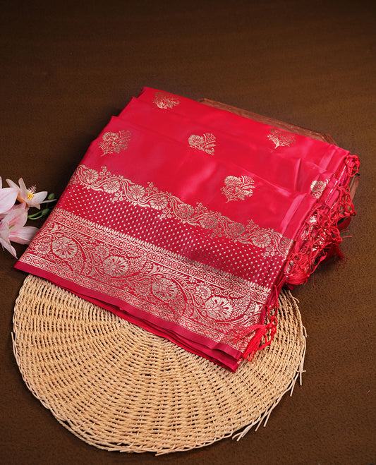 Red colour Banaras Satin Crepe saree featuring gold zari floral motifs on the body, a richly detailed traditional border with intricate gold zari work, and paired with a matching blouse.