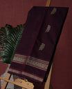 Deep maroon colour pure Kanchi cotton saree adorned with subtle beige zari motifs across the body,  The intricate zari woven border adds a touch of tradition & Includes a matching blouse piece for a complete look.