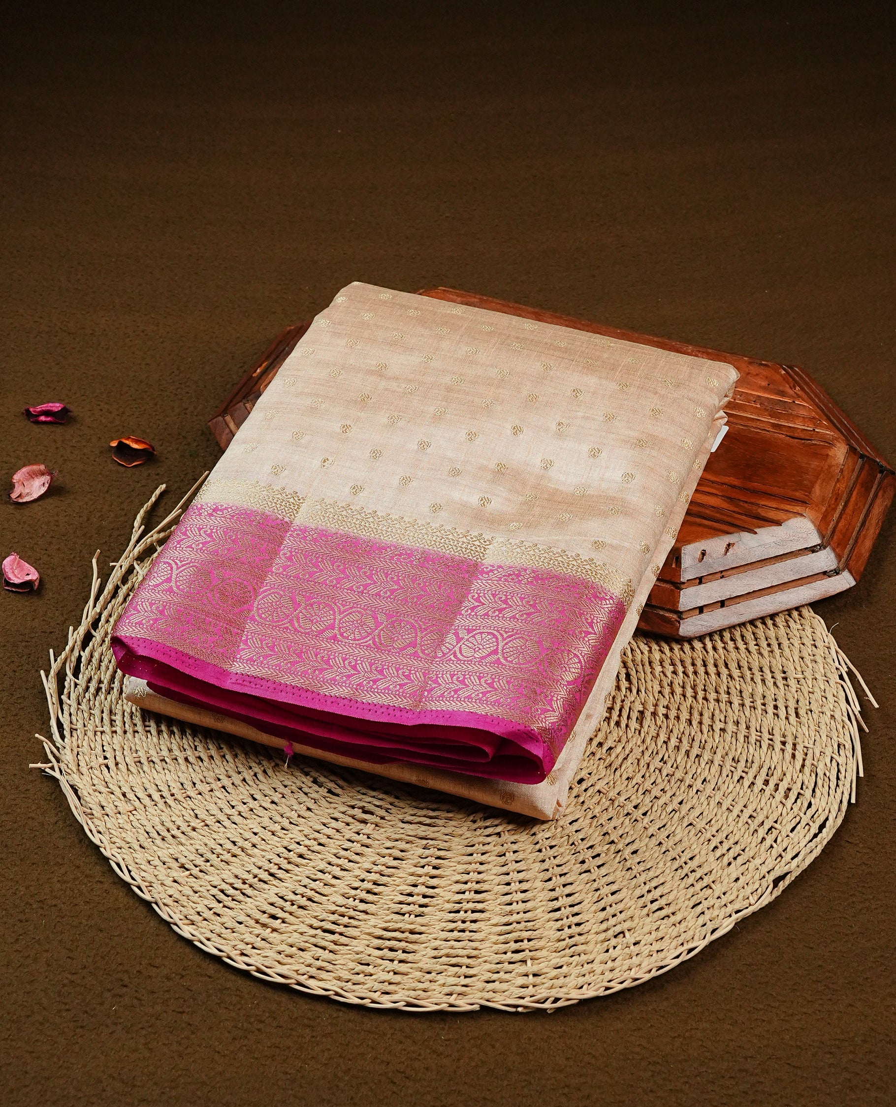 Light Gold Tussar saree featuring Gold zari buttas on body, complemented by contrast Magenta Colour with Gold zari border, comes with matching blouse piece.