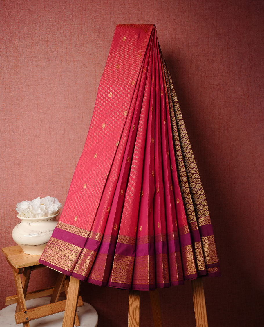 Magenta colour soft silk saree featuring Gold zari stripes on body, complemented by contrast purple colour with traditional border, paired with matching blouse piece.