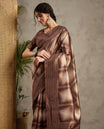 Brown toned semi Tussar saree featuring contemporary fancy prints across the body, enhanced with a subtle Katha style stitched border, paired with a matching blouse for a stylish and elegant ethnic look.