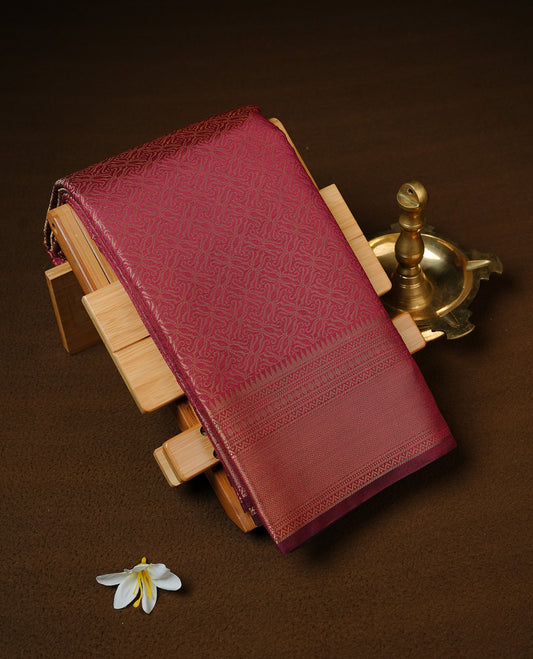 Maroon colour Semi Wedding silk saree featuring gold zari kodi pattern across body, complemented by self colour with traditional border, paired with matching blouse piece.