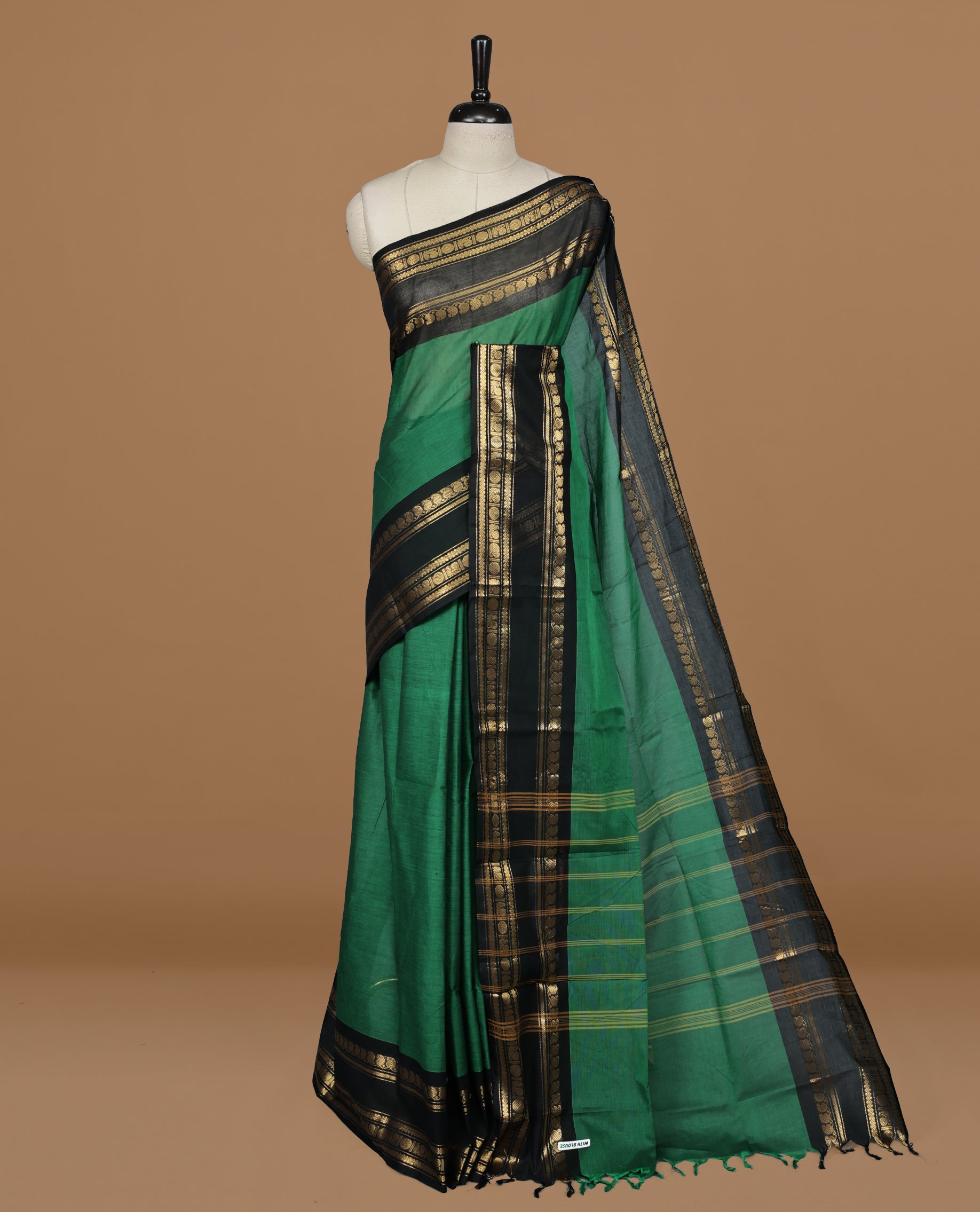 Green colour Chettinad cotton saree featuring motifs on body , complemented by contrast Black colour with zari border, comes with matching blouse piece.