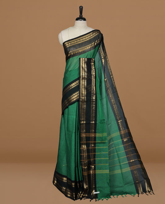 Green colour Chettinad cotton saree featuring motifs on body , complemented by contrast Black colour with zari border, comes with matching blouse piece.