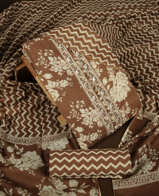 Brown colour churidar set with cream colour floral print, stone and thread embroidery and detailing, paired with matching pant and dupatta.