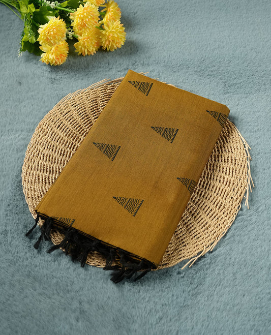 Dark mustard colour poly cotton saree with black temple motifs on the body, paired with a matching pallu with black woven traditional border, and a coordinated all‑over geometric printed blouse piece.