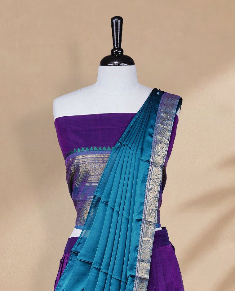 Purple colour Half saree featuring Plain skirt with Zari border on contrast Teal colour border, Unstitched Blouse and matching dupatta.
