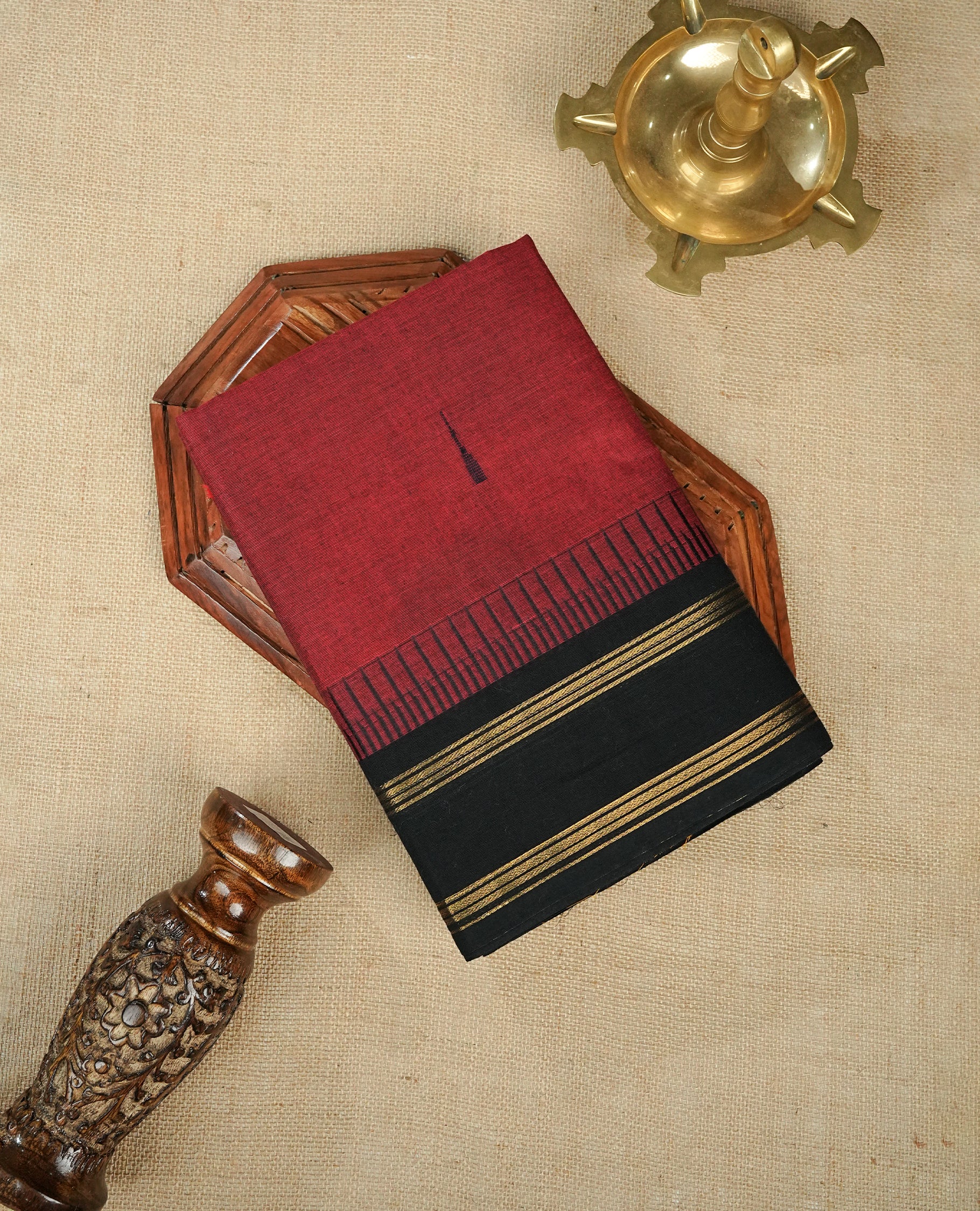 Maroon Colour Chettinad Cotton Saree Featuring Plain Body, Complemented by Black With Gold Zari Border & Contrast Colour Striped Pallu, Paired with a Matching Blouse Piece.